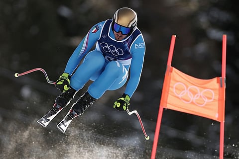 Italy's Dominik Paris speeds down the course during an alpine ski, men's downhill official training, at the 2026 Winter Olympics, in Bormio, Italy.