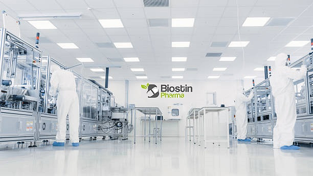 Pharmaceutical lab with technicians in protective suits at Biostin Pharma