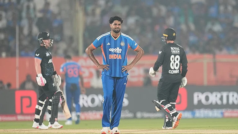 India's Harshit Rana reacts after a boundary by New Zealand's Tim Seifert, left, during the fourth T20 cricket match between India and New Zealand in Visakhapatnam. - | Photo: AP/Aijaz Rahi