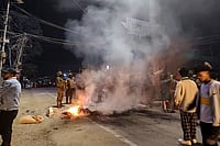 PTI : Security personnel keep watch as people stage a protest against the participation of MLAs from the Kuki-Zo community in Manipur government formation, in Churachandpur district.