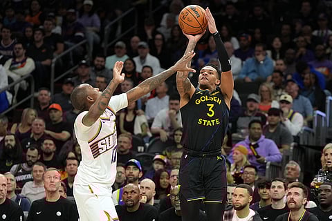 Golden State Warriors guard Will Richard (3) shoots over Phoenix Suns guard Jamaree Bouyea during the second half of an NBA basketball game, in Phoenix.
