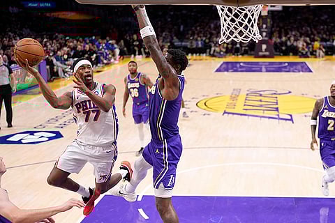 Philadelphia 76ers guard Vj Edgecombe, left, shoots as Los Angeles Lakers center Deandre Ayton defends during the second half of an NBA basketball game in Los Angeles.