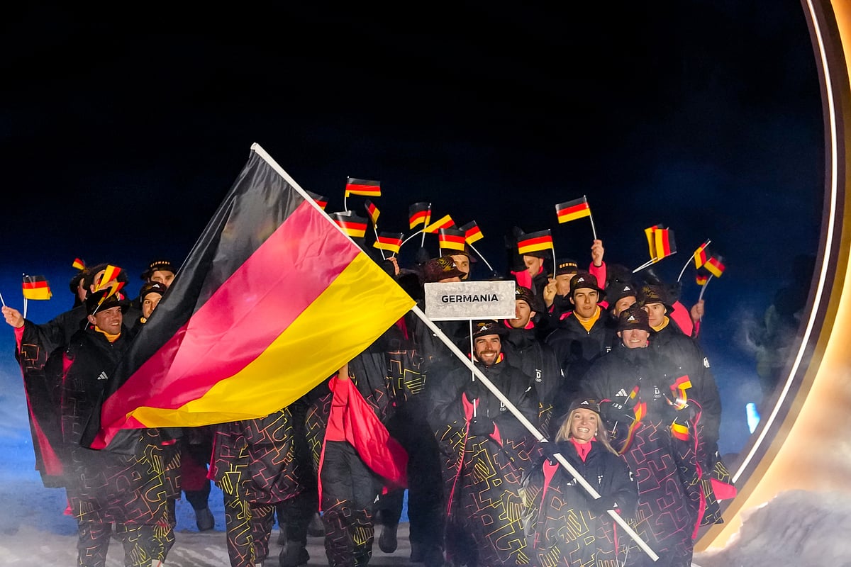 Katharina Schmid, the flag bearer of Germany, takes part in the athletes parade during the Olympic opening ceremony at the 2026 Winter Olympics, in Predazzo, Italy, Friday, Feb. 6, 2026.