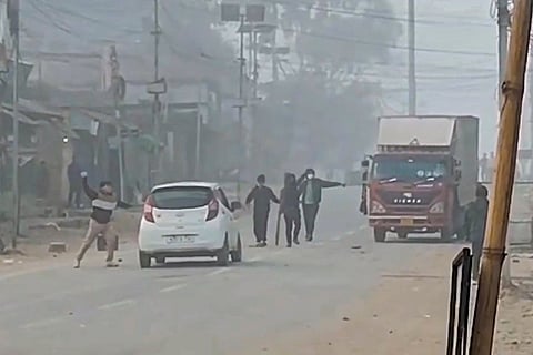 Protestors attack a vehicle during a 24-hour shutdown imposed in protest against the participation of MLAs from the Kuki-Zo community in Manipur government formation, in Churachandpur district.