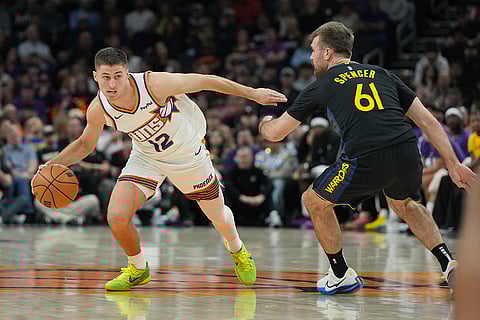 Phoenix Suns guard Collin Gillespie drives past Golden State Warriors guard Pat Spencer (61) during the first half of an NBA basketball game in Phoenix. 