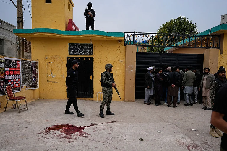 Pakistani paramilitary and police commandos take positions at the site of a bomb explosion at a Shiite mosque, in Islamabad, Pakistan. - Photo: AP/Anjum Naveed