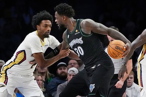 New Orleans Pelicans guard Herb Jones, left, defends against Minnesota Timberwolves forward Julius Randle (30) in the fourth quarter of an NBA basketball game in Minneapolis. 