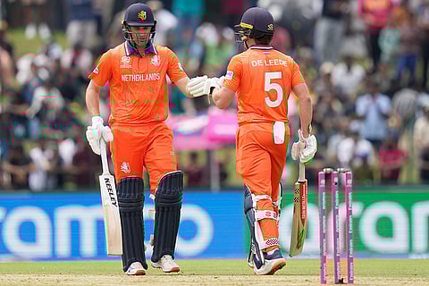 Netherlands' Colin Ackermann, left, and batting partner Bas de Leede touch gloves during the T20 World Cup cricket match between Netherlands and Pakistan in Colombo, Sri Lanka.