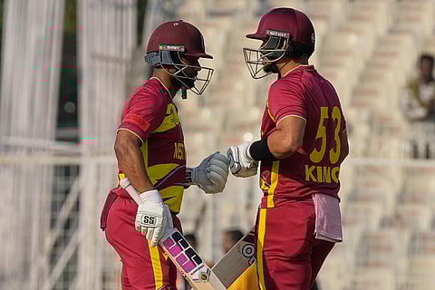 West Indies' captain Shai Hope, left, Brandon King encourage each other as they bat during the T20 World Cup cricket match between Scotland and West Indies in Kolkata.