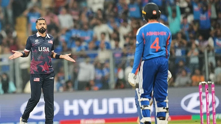United States' Ali Khan, left, celebrates the wicket of India's Abhishek Sharma, right, during the T20 World Cup cricket match between India and the United States in Mumbai. - | Photo: AP/Rafiq Maqbool