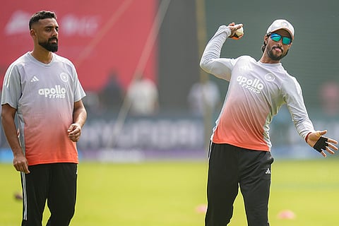 India's Varun Chakravarthy and Tilak Varma during a training session ahead of the ICC Men's T20 World Cup 2026 cricket match against USA, in Mumbai.
