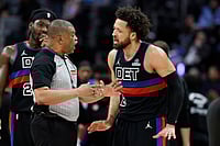 Detroit Vs New York, NBA: 2-Way Daniss Jenkins Inspires Pistons To Commanding 118-80 Win Over Knicks | Photo: AP/Duane Burleson : Detroit Pistons guard Cade Cunningham, right, argues with official Tony Brothers, front left, during the second half of an NBA basketball game against the New York Knicks in Detroit.