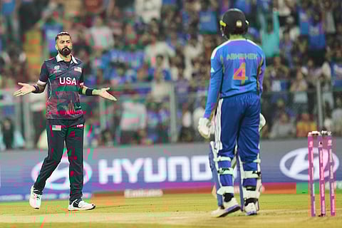 United States' Ali Khan, left, celebrates the wicket of India's Abhishek Sharma, right, during the T20 World Cup cricket match between India and the United States in Mumbai.