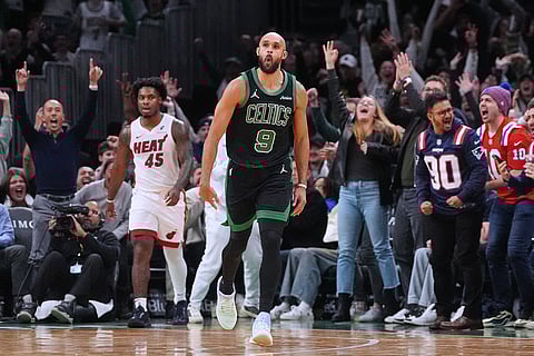 Boston Celtics guard Derrick White (9) celebrates after hitting a 3-point basket late in the second half of an NBA basketball game against the Miami Heat, in Boston. 