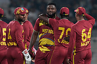 | Photo: AP/Bikas Das : West Indies' Romario Shepherd, third from right, celebrates with teammates after taking five-wicket in the match during the T20 World Cup cricket match between Scotland and West Indies in Kolkata.