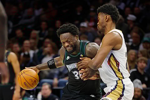 Minnesota Timberwolves forward Julius Randle, left, works against New Orleans Pelicans center Yves Missi in the first quarter of an NBA basketball game in Minneapolis. 