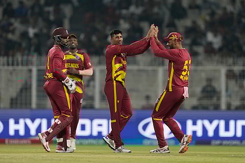 West Indies' Gudakesh Motie celebrates with teammates the wicket of Scotland's Tom Bruce during the T20 World Cup cricket match between Scotland and West Indies in Kolkata.