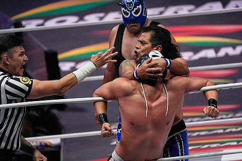 Lucha Libre wrestlers Calavera Jr., front right, and Virus fight at the Arena Mexico in Mexico City.