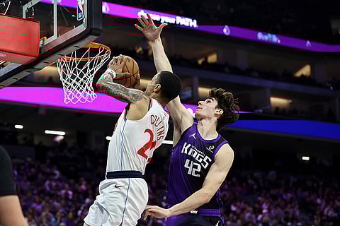Los Angeles Clippers forward John Collins (20) draws the foul on Sacramento Kings center Maxime Raynaud (42) as he goes up for a dunk during the second half of an NBA basketball game in Sacramento, California.