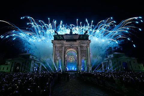 Italian former skier Deborah Compagnoni and Italian former skier Alberto Tomba light the cauldron at the Arco della Pace during the Olympic opening ceremony at the 2026 Winter Olympics, in Milan, Italy.