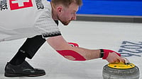 Winter Olympics Milano Cortina 2026: How Many New Sports Are Added? Which Cities Will Host The Event? All You Must Know | Photo: AP/Misper Apawu : Switzerland's Yannick Schwaller in action during the mixed doubles round robin phase of the curling competition against Estonia at the 2026 Winter Olympics, in Cortina d'Ampezzo, Italy.