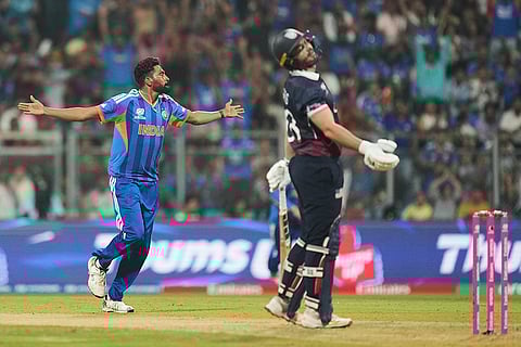 India's Mohammed Siraj, left, celebrates the wicket of United States' Andries Gous, right, during the T20 World Cup cricket match between India and the United States in Mumbai.