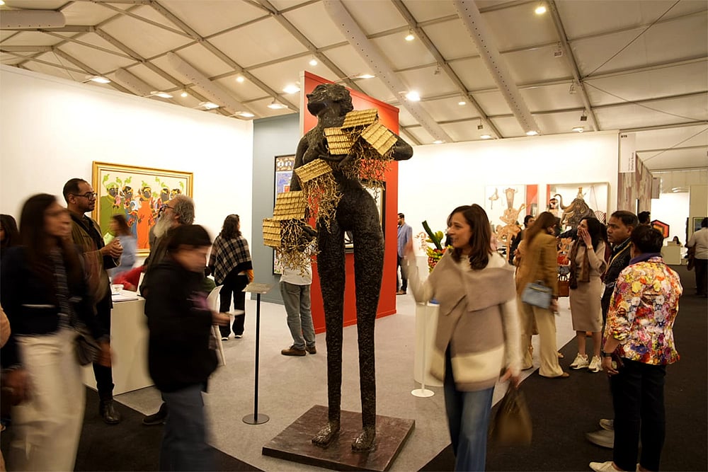 India Art Fair 2026 photo-Art enthusiasts examine works at the India Art Fair