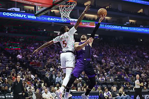 Sacramento Kings guard Zach LaVine (8) draws the foul on Los Angeles Clippers forward Derrick Jones Jr. (5) during the first half of an NBA basketball game in Sacramento, California.