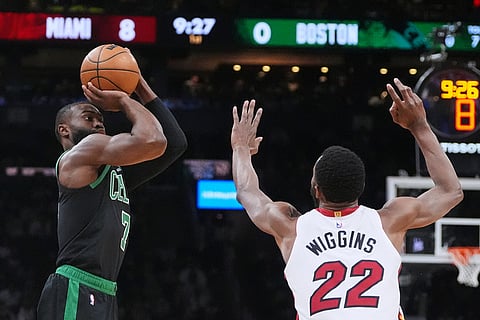 Boston Celtics guard Jaylen Brown (7) looks to shoot over Miami Heat forward Andrew Wiggins (22) during the first half of an NBA basketball game, in Boston. 