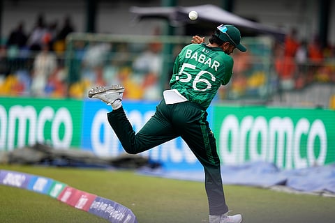 Pakistan's Babar Azam throws the ball back as he jumps across the boundry rope during the T20 World Cup cricket match between Netherlands and Pakistan in Colombo, Sri Lanka.