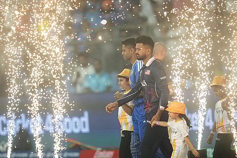 India's captain Suryakumar Yadav and United States' captain Monank Patel arrives with their team for national anthem during the T20 World Cup cricket match between India and the United States in Mumbai.