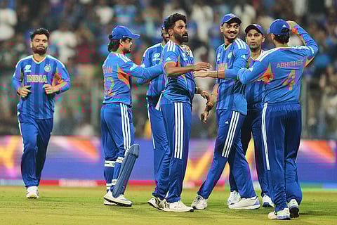 India's Mohammed Siraj, center, celebrates with teammates the wicket of United States' Andries Gous, right, during the T20 World Cup cricket match between India and the United States in Mumbai.