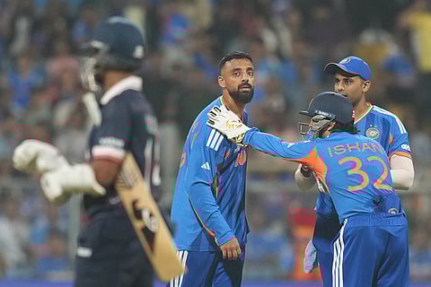 India's Varun Chakravarthy, center, celebrates with teammates the wicket of United States' Milind Kumar during the T20 World Cup cricket match between India and the United States in Mumbai.