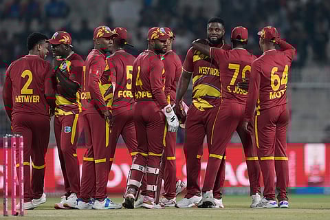 West Indies' Romario Shepherd ,third from right, celebrates with teammates after taking five-wicket in the match during the T20 World Cup cricket match between Scotland and West Indies in Kolkata.