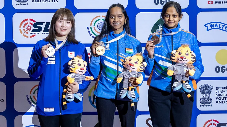 India's Meghana Sajjanar (right) and Elavenil Valarivan (centre) on the podium after bagging bronze and gold medals at the Asian Championship 2026's women’s 10m air rifle event. - X/NRAI