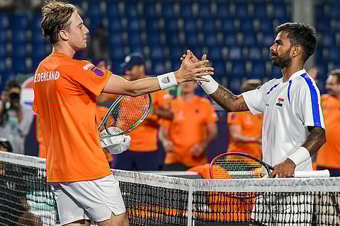Netherlands' Guy Den Ouden, left, exchanges greetings with India's Sumit Nagal after the former's victory in the 2026 Davis Cup Qualifiers first round tie, at SM Krishna Tennis Stadium, in Bengaluru, Karnataka.