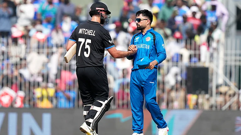 New Zealand's Daryl Mitchell, left, shakes hands with Afghanistan's captain Rashid Khan after New Zealand won their T20 World Cup cricket match against Afghanistan in Chennai, India, Sunday, Feb. 8, 2026 - (AP Photo/Mahesh Kumar A.)