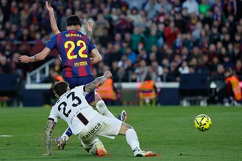 Barcelona's Marc Bernal (22) scores his side's 3rd goal during the Spanish La Liga soccer match between Barcelona and Mallorca in Barcelona, Spain.