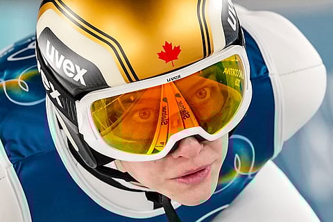 Nicole Maurer, of Canada, goes down the ramp during her trial jump of the ski jumping women's normal hill individual, at the 2026 Winter Olympics, in Predazzo, Italy.