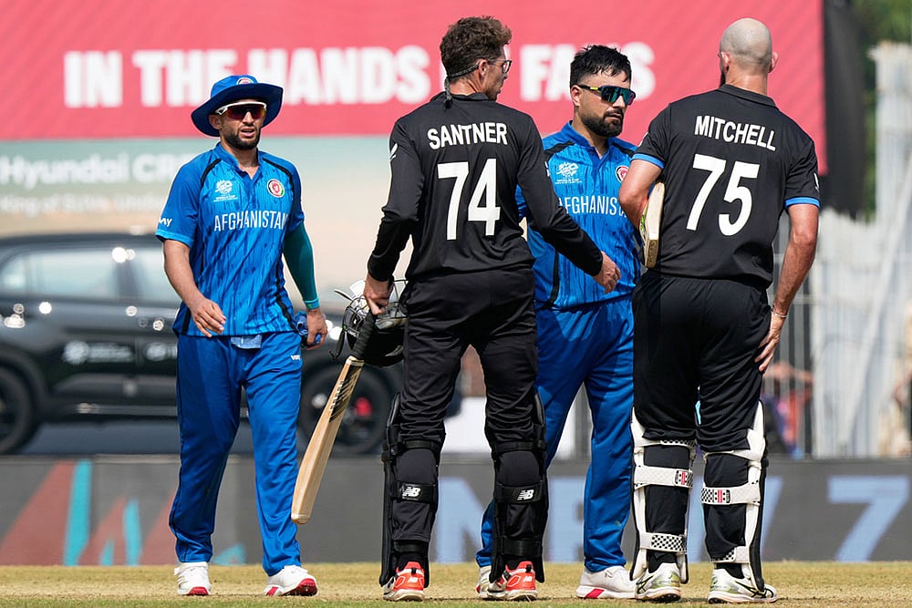 Afghanistan's captain Rashid Khan, center, greets New Zealand's Daryl Mitchell, right, and Mitchel Santner after New Zealand won their T20 World Cup cricket match against Afghanistan in Chennai, India. - | Photo: AP/Mahesh Kumar A.