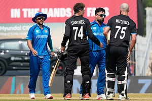 | Photo: AP/Mahesh Kumar A. : Afghanistan's captain Rashid Khan, center, greets New Zealand's Daryl Mitchell, right, and Mitchel Santner after New Zealand won their T20 World Cup cricket match against Afghanistan in Chennai, India.