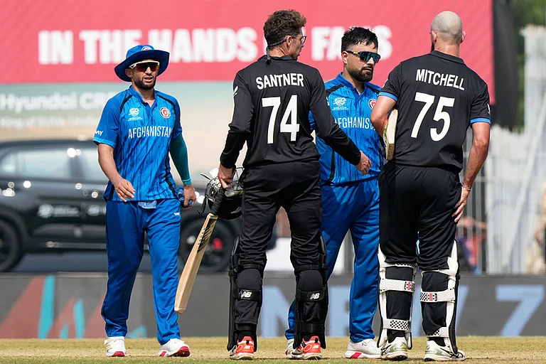Afghanistan's captain Rashid Khan, center, greets New Zealand's Daryl Mitchell, right, and Mitchel Santner after New Zealand won their T20 World Cup cricket match against Afghanistan in Chennai, India. - | Photo: AP/Mahesh Kumar A.