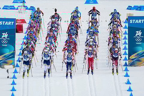 Jessie Diggins of the United States, center, and others start in the cross country skiing women's 10km + 10km skiathlon at the 2026 Winter Olympics, in Tesero, Italy.