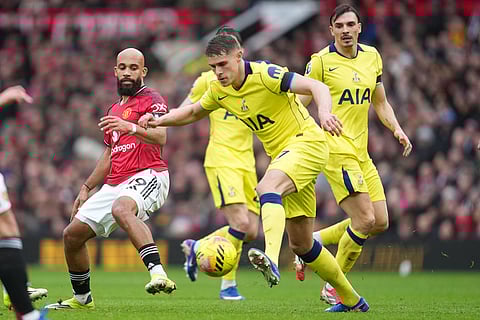 Tottenham's Micky van de Vencontrolls the ball in front of Manchester United's Bryan Mbeumo during the English Premier League soccer match between Manchester United and Tottenham in Manchester, England.
