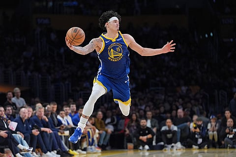 Golden State Warriors forward Gui Santos attemps to retrieve the ball during the second half of an NBA basketball game against the Los Angeles Lakers in Los Angeles.