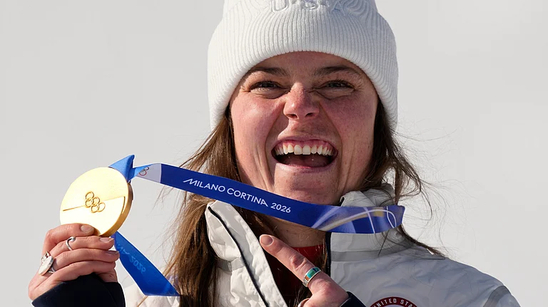 United States' Breezy Johnson shows her gold medal in the alpine ski women's downhill race, at the 2026 Winter Olympics, in Cortina d'Ampezzo, Italy, Sunday, Feb. 8, 2026. - (AP Photo/Andy Wong)