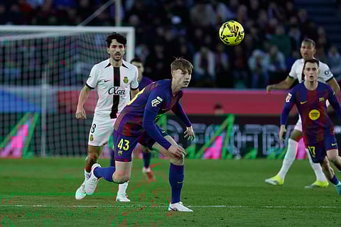 Barcelona's Tommy Marques (43) goes for the ball during the Spanish La Liga soccer match between Barcelona and Mallorca in Barcelona, Spain.