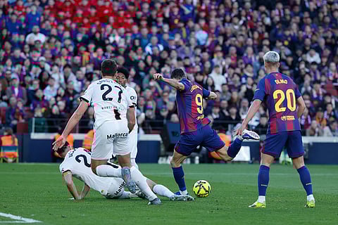 Barcelona's Robert Lewandowski (9) scores his side's opening goal during the Spanish La Liga soccer match between Barcelona and Mallorca in Barcelona, Spain.