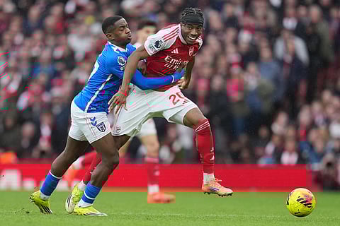 Sunderland's Noah Sadiki holds Arsenal's Noni Madueke during the English Premier League soccer match between Arsenal and Sunderland in London, England.