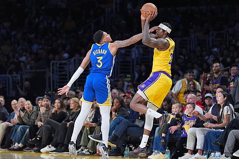 Golden State Warriors guard Will Richard (3) pressures Los Angeles Lakers forward Jarred Vanderbilt (2) during the first half of an NBA basketball game in Los Angeles.